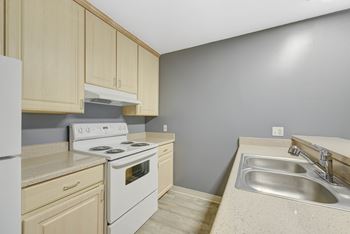 Fully equipped island kitchen at oak village apartments, oakland